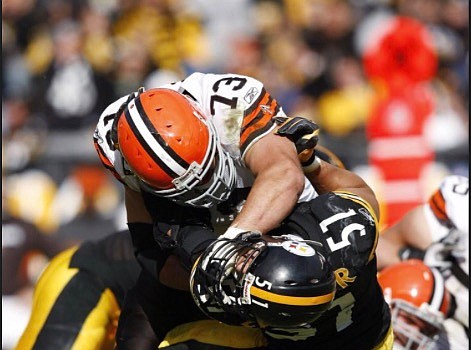 This photo of Joe Thomas burying Pittsburgh Steelers linebacker James Farrior is a favorite of his father Eric. (Courtesy of Joe Thomas)
