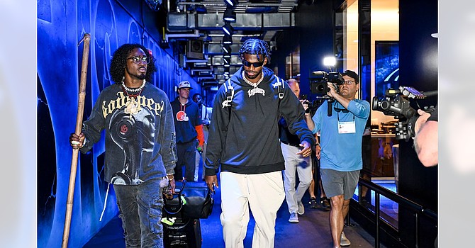 Even Shedeur Sanders' arrival at Bank of America Stadium was a big event on Friday. That's DB Tony Brown to Sanders' right, toting a Moses-like staff. (Cleveland Browns)